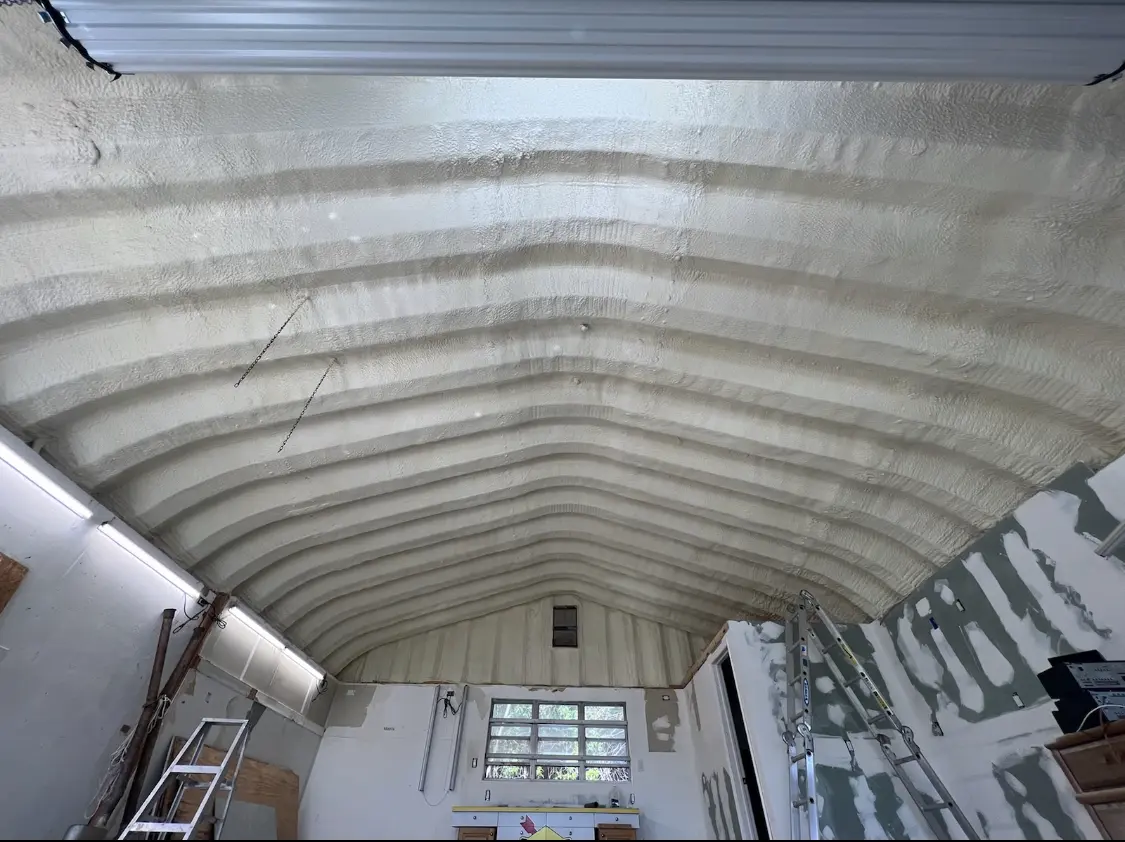 Spray polyurethane foam applied to the underside of a metal roof deck in Ogden